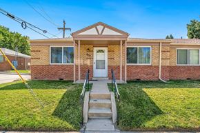 Denver apartment for rent - A brick house with a front porch and a white door.
