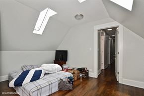 Chicago apartment for rent - a bedroom with a bed and a tv in a loft