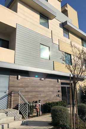Van Nuys apartment for rent - a large building with a staircase and a glass door
