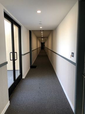 Van Nuys apartment for rent - a hallway with doors and windows in a building