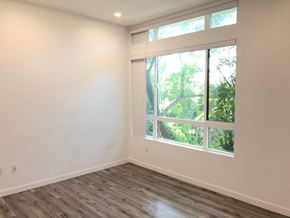 Van Nuys apartment for rent - a living room with a large window and wooden floors
