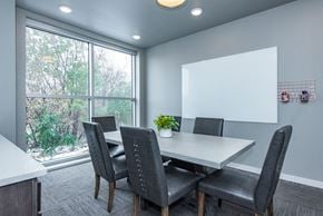 Lakeville apartment for rent - A conference room with a white table and grey chairs.