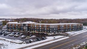 Lakeville apartment for rent - A parking lot with cars and apartment buildings in the background.