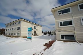 Edmonton apartment for rent - a building with a sign in the snow