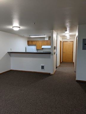 Seattle apartment for rent - an empty room with a kitchen and a hall way