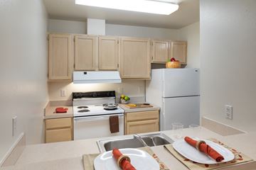 Seattle apartment for rent - a kitchen with white appliances and a table with plates of food