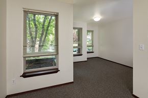 Seattle apartment for rent - a living room with a large window and a carpeted floor