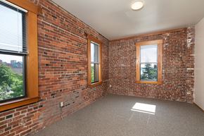 Seattle apartment for rent - A room with a brick wall and a window.