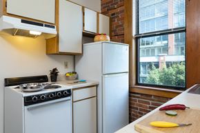 Seattle apartment for rent - A kitchen with a white stove and a white refrigerator.