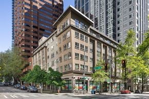 Seattle apartment for rent - A street view of a city with a building in the middle.