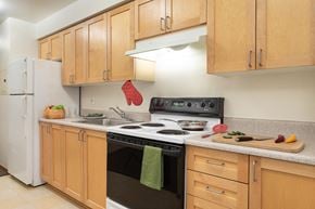 Seattle apartment for rent - A kitchen with wooden cabinets and a black stove top.
