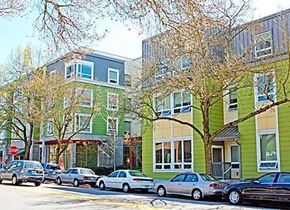 Seattle apartment for rent - a city street with cars parked in front of buildings