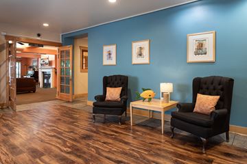 Seattle apartment for rent - a living room with two black chairs and a blue wall