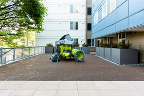 Seattle apartment for rent - A playground with a slide and a yellow barrel.