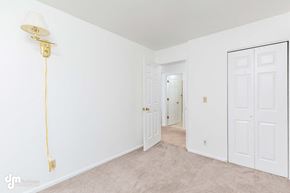Anchorage house for rent - a bedroom with white walls and white doors and a lamp