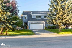Anchorage house for rent - a house with a white garage door in front of a street