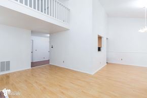 Anchorage house for rent - an empty living room with white walls and wood floors