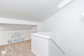 Anchorage house for rent - a living room with a staircase and a loft with a railing and a stairwell