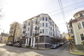 San Francisco apartment for rent - A street view of a residential area with cars parked on the side of the road.