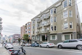 San Francisco apartment for rent - A street view of a residential area with cars parked on the side of the road.