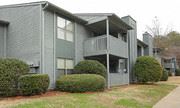 Birmingham apartment for rent - a gray house with a porch and some bushes