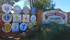 Arroyo Grande apartment for rent - a sign for the welcome to arroyo grande sign with many different signs