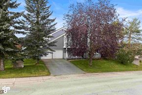 Anchorage house for rent - a house with a driveway and trees in front of it