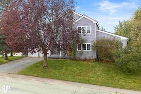 Anchorage house for rent - a house with a lawn and a tree in front of it