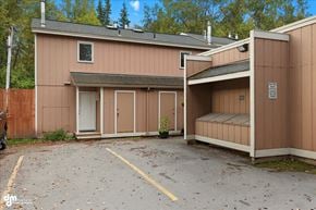 Anchorage apartment for rent - A small building with a garage door and a covered area.