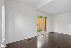Anchorage apartment for rent - A room with a slanted ceiling and a door leading outside.