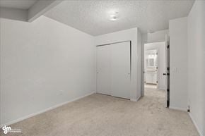 Anchorage apartment for rent - A white bedroom with a carpeted floor and a white door.