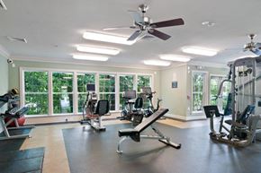 Wayne apartment for rent - a gym with several machines and a ceiling fan