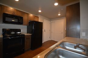 Eagle apartment for rent - Image of kitchen sink, microwave, refrigerator, stove and cabinets