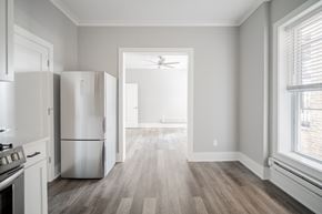Chicago apartment for rent - an empty kitchen and living room with a refrigerator