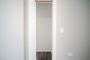 Chicago apartment for rent - a bedroom with white walls and wood floors and a closet