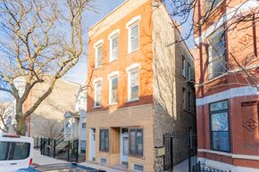 Chicago apartment for rent - a brick building with a van parked in front of it