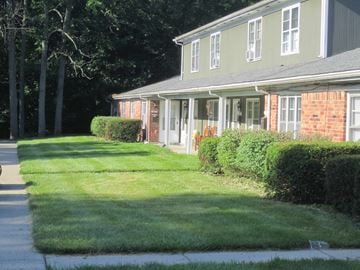 Indianapolis apartment for rent - a house with a lawn and a sidewalk in front of it