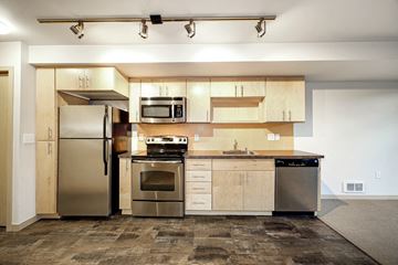 Seattle apartment for rent - a kitchen with stainless steel appliances and wooden cabinets