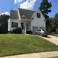 Selma apartment for rent - A white house with a silver car parked in front.