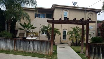 San Diego apartment for rent - a backyard with a wooden fence and a house