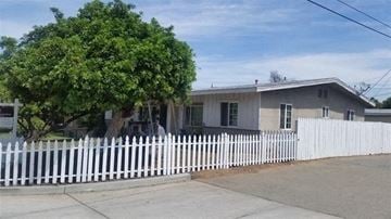 Escondido apartment for rent - A white picket fence in front of a house.