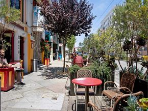 San Francisco apartment for rent - a city street with tables and chairs and trees