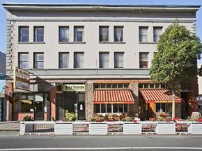 San Francisco apartment for rent - a street view of a building with a restaurant on it