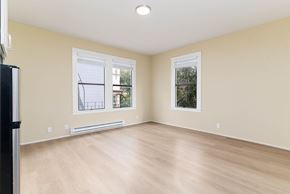 San Francisco apartment for rent - A room with a wooden floor and two windows.