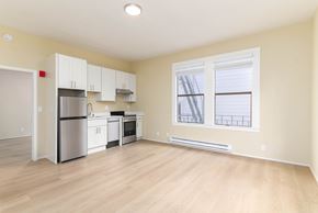San Francisco apartment for rent - A kitchen with white appliances and wooden floors.