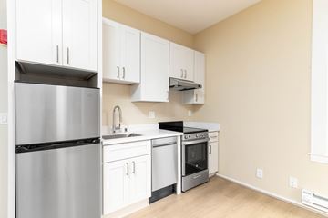 San Francisco apartment for rent - A kitchen with white cabinets and stainless steel appliances.