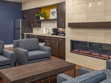 Abingdon apartment for rent - a living room with a fireplace and a table with chairs