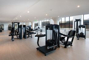 Philadelphia apartment for rent - a gym with various exercise equipment on a wooden floor