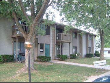 Vicksburg apartment for rent - a house with a yard and a tree in front of it