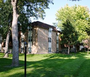 Mankato apartment for rent - a large brick building with trees in front of it